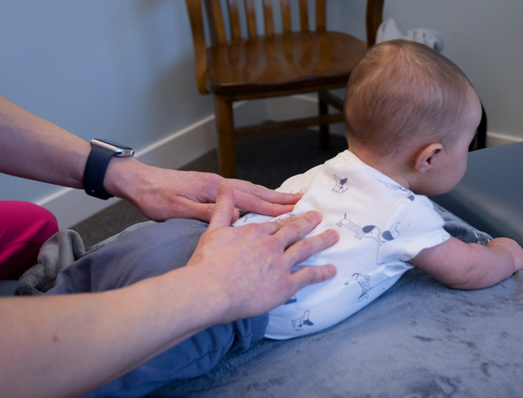 Dr. Kelsey analyzing colic in a baby.