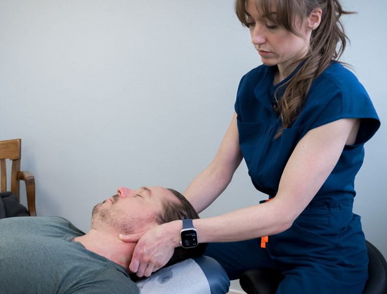 Dr. Kelsey working on a patient's neck.