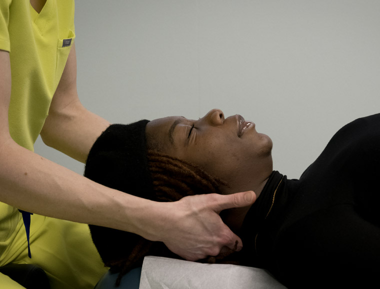 Dr. Kelsey treating a patient with tension headache