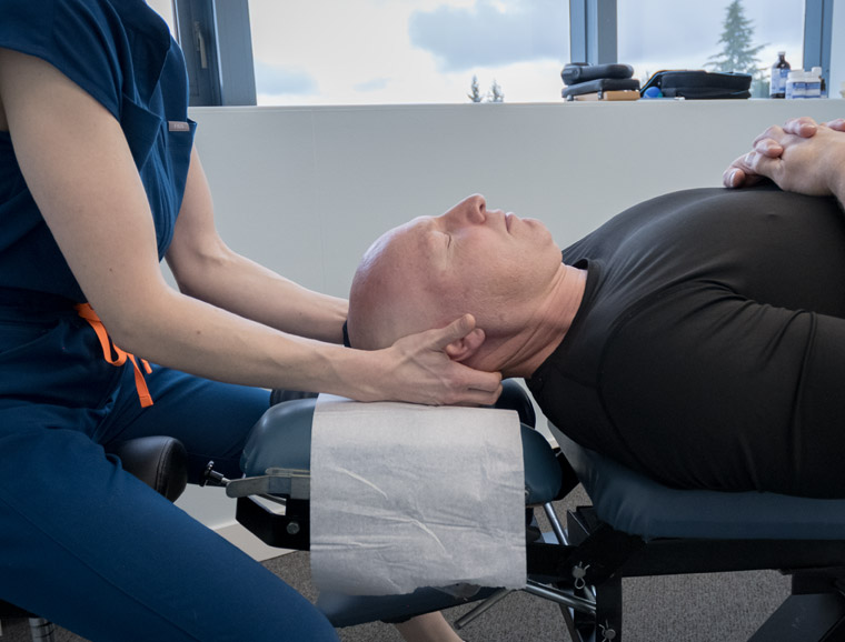 Dr. Kelsey working on the client's neck.